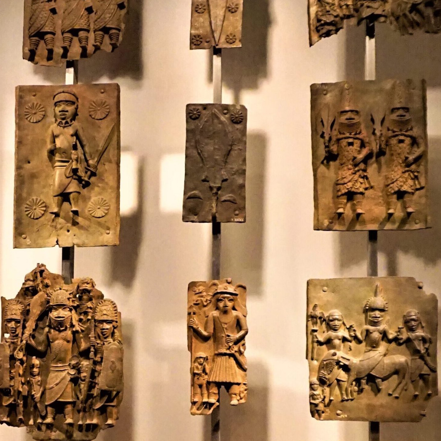 photograph of a few benin bronzes hung up